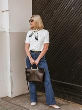 a lady in a round neck knitted short-sleeve cardigan